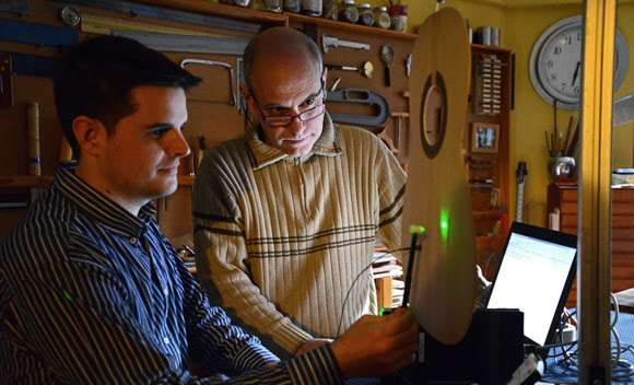 Marco A. Pérez (left) and Antonio Manjón perform a modal test on a guitar soundboard using a Brüel & Kjær impact hammer