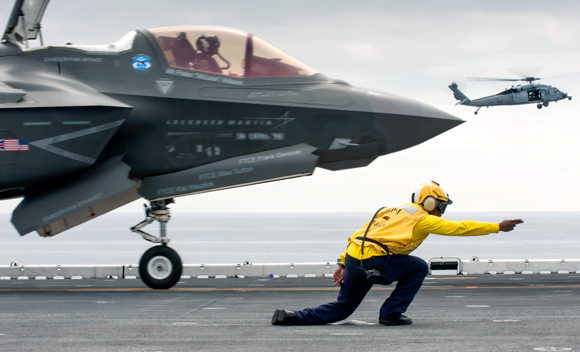 Ground crew work in very close proximity to the F-35 fighter jet,