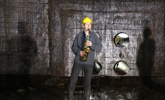 Trevor Cox playing the saxophone in the oil storage tank