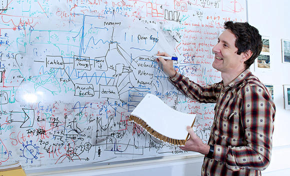 Trevor Cox writing on the white board in his office