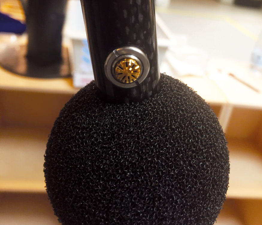 Close-up picture of a single microphone with the wind screen pushed aside
