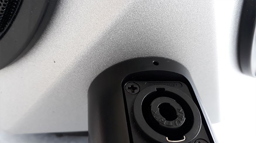 Mounting piece with vent hole above the connector