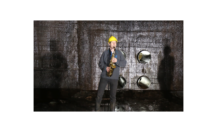 Trevor Cox playing the saxophone in the oil storage tank