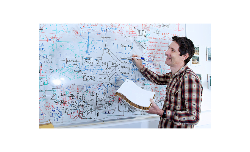 Trevor Cox writing on the white board in his office